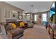 Inviting living room with a plush sofa, neutral decor, and an open layout to the entrance and kitchen at 6265 Fairmont Ln, Palmetto, FL 34221