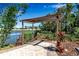 A lovely pergola sits near the lake, providing a beautiful shaded spot in the community with building views at 6265 Fairmont Ln, Palmetto, FL 34221