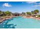 A stunning pool and covered pavilion are framed by palm trees and sun loungers for resort style living in the community at 6265 Fairmont Ln, Palmetto, FL 34221