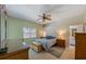 Bedroom with pale green walls, standard ceiling fan, and traditional wood furnishings at 6345 Stone River Rd # 6345, Bradenton, FL 34203