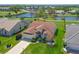 Stunning aerial view of home with tile roof, pond, and lush landscaping in a vibrant community at 6514 Stone River Rd, Bradenton, FL 34203