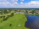 Scenic aerial view of the golf course and community with lakes, fairways, and the clubhouse at 6514 Stone River Rd, Bradenton, FL 34203