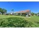 Lush backyard with green lawn, mature trees, and views of surrounding homes at 6514 Stone River Rd, Bradenton, FL 34203