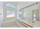 Bright bathroom features double sinks, a large mirror, and a soaking tub at 6514 Stone River Rd, Bradenton, FL 34203
