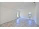 A bright bedroom with tiled floors, a ceiling fan, and multiple windows at 6514 Stone River Rd, Bradenton, FL 34203