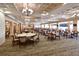 Spacious formal dining area featuring tables, chairs, elegant chandeliers, and large windows at 6514 Stone River Rd, Bradenton, FL 34203