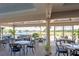 Spacious outdoor dining area with comfortable seating and scenic views of the lake and golf course at 6514 Stone River Rd, Bradenton, FL 34203