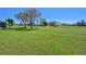 Picturesque view of a well-maintained golf course with a pond and blue sky at 6514 Stone River Rd, Bradenton, FL 34203