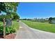 Scenic view of a golf course path with lush green grass, mature trees, and a water feature at 6514 Stone River Rd, Bradenton, FL 34203