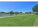 Picturesque view of a lush green golf course with a tranquil pond at 6514 Stone River Rd, Bradenton, FL 34203