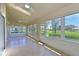 Bright sunroom with tiled floors, multiple windows showcasing lush green views at 6514 Stone River Rd, Bradenton, FL 34203