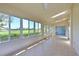 Bright sunroom with tiled floors, multiple windows showcasing lush green views at 6514 Stone River Rd, Bradenton, FL 34203