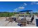Community tennis court with seating, shade and tables, offering a great location for sport and relaxation at 6514 Stone River Rd, Bradenton, FL 34203