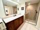 Modern bathroom featuring a glass-enclosed shower and a sleek vanity with ample counter space and dark wood cabinets at 6707 Stone River Rd # 105, Bradenton, FL 34203