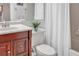 Functional bathroom featuring a modern vanity, toilet, and shower/tub combination with a white shower curtain at 6707 Stone River Rd # 105, Bradenton, FL 34203