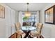 Cozy dining area boasting hard wood floors, modern light fixture and a view to the outside patio at 6707 Stone River Rd # 105, Bradenton, FL 34203