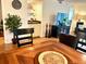 Cozy dining area featuring a wooden table with black chairs, decorative candles, and a view into the living room at 6707 Stone River Rd # 105, Bradenton, FL 34203