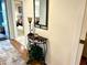 Welcoming entryway with a decorative table and mirror, leading to a view of the bedroom and natural light at 6707 Stone River Rd # 105, Bradenton, FL 34203