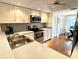 Well-lit kitchen with stainless steel appliances, updated cabinets, and breakfast nook with dining area at 6707 Stone River Rd # 105, Bradenton, FL 34203