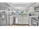 Bright kitchen featuring white cabinetry, stainless steel appliances, and a convenient breakfast bar at 6707 Stone River Rd # 105, Bradenton, FL 34203