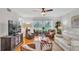 Bright living room boasting ceiling fan, hardwood floors, and a view of the manicured lawn at 6707 Stone River Rd # 105, Bradenton, FL 34203