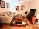 Comfortable living room with a couch, chair, entertainment center and an eye-catching geometric rug at 6707 Stone River Rd # 105, Bradenton, FL 34203