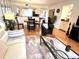 Spacious open-concept living room showcasing wood floors and a view into the kitchen and dining area at 6707 Stone River Rd # 105, Bradenton, FL 34203