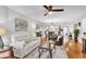 Open-concept living room featuring wood floors, neutral colors, and a view into the kitchen and dining area at 6707 Stone River Rd # 105, Bradenton, FL 34203