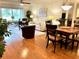 Open-concept living area with a sofa and chairs, a dining table set for four, and sliding glass doors to the backyard at 6707 Stone River Rd # 105, Bradenton, FL 34203