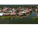 Scenic aerial perspective of a residential community with manicured lawns and a tranquil pond at 7118 42Nd E Ct, Sarasota, FL 34243