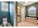 Bathroom features a soaking tub, toilet, and separate vanity area at 7118 42Nd E Ct, Sarasota, FL 34243