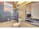 Bathroom showcasing tiled shower, vanity with sink, and natural light from a sky light at 7118 42Nd E Ct, Sarasota, FL 34243