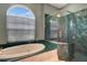 Primary bathroom with a luxurious soaking tub and a walk-in shower at 7118 42Nd E Ct, Sarasota, FL 34243
