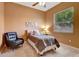 Cozy bedroom with tile flooring, a comfy chair, and a bright window view, great for relaxation at 7118 42Nd E Ct, Sarasota, FL 34243