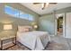 Bedroom with neutral walls, ceiling fan, and an open doorway to the kitchen at 7118 42Nd E Ct, Sarasota, FL 34243
