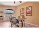 Cozy dining room with view of the pool area and a dark wood table at 7118 42Nd E Ct, Sarasota, FL 34243