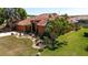 A well-maintained home featuring terra cotta roofing and an attractive, landscaped yard at 7118 42Nd E Ct, Sarasota, FL 34243