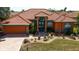 Inviting single-story home featuring terra cotta roofing and a well-manicured front yard at 7118 42Nd E Ct, Sarasota, FL 34243