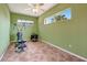 Spacious, adaptable flex room with large windows, a ceiling fan, and durable tile flooring for easy maintenance at 7118 42Nd E Ct, Sarasota, FL 34243