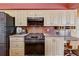 Close-up of the kitchen with stainless steel appliances, light wood cabinets, and tile backsplash at 7118 42Nd E Ct, Sarasota, FL 34243