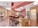 Open-concept kitchen with a breakfast bar, cream cabinetry, and seamless transition to the dining and living areas at 7118 42Nd E Ct, Sarasota, FL 34243