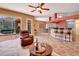 Open-concept layout connecting the living area to the dining and kitchen, with access to the outdoor patio at 7118 42Nd E Ct, Sarasota, FL 34243