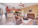 Spacious living area with tile floors, ceiling fan, and seamless transition to the kitchen at 7118 42Nd E Ct, Sarasota, FL 34243