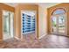 Bright living room features tile floors, blue built-ins, and a front door with a transom window at 7118 42Nd E Ct, Sarasota, FL 34243