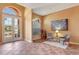 Inviting living room featuring tiled floors and double door entry with arch window at 7118 42Nd E Ct, Sarasota, FL 34243