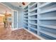 Bright office space with built-in shelving and an open doorway to a dining area, perfect for working from home at 7118 42Nd E Ct, Sarasota, FL 34243