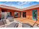 A beautiful orange outdoor patio provides ample seating, ceiling fans, and stylish tile perfect for entertaining at 7118 42Nd E Ct, Sarasota, FL 34243