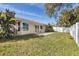 Nice backyard with green grass, a patio, and white vinyl fence at 7211 Antigua Pl, Sarasota, FL 34231