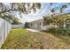 Backyard with grass, patio and mature trees at 7211 Antigua Pl, Sarasota, FL 34231