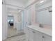 Bright bathroom with large mirror, wood look floors, and vanity at 7211 Antigua Pl, Sarasota, FL 34231
